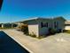 Exterior view showing a carport, flower beds, and a concrete walkway at 5546 Benton St, Zephyrhills, FL 33542