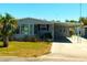Charming single-story home with a covered carport and well-maintained landscaping at 5546 Benton St, Zephyrhills, FL 33542