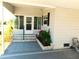 Charming covered front porch featuring steps and a small flower bed at 5546 Benton St, Zephyrhills, FL 33542