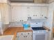 Traditional kitchen features white cabinets, wood countertops, and appliances at 5546 Benton St, Zephyrhills, FL 33542