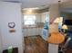 Efficient kitchen layout featuring bright cabinets, a white appliance suite, and a cozy breakfast bar at 5546 Benton St, Zephyrhills, FL 33542