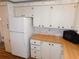 Efficient kitchen with plentiful cabinetry, a white refrigerator, and a microwave at 5546 Benton St, Zephyrhills, FL 33542