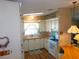 Efficient kitchen layout featuring bright cabinets, a white appliance suite, and a cozy breakfast bar at 5546 Benton St, Zephyrhills, FL 33542