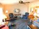 Cozy living room features a ceiling fan, comfortable seating, and a dining area at 5546 Benton St, Zephyrhills, FL 33542