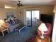 Inviting living room with sliding glass doors, leading to an enclosed porch at 5546 Benton St, Zephyrhills, FL 33542