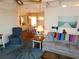 Comfortable living room with a sofa and an arm chair, with dining area in the background at 5546 Benton St, Zephyrhills, FL 33542