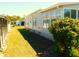Side yard view featuring well-maintained grass and minimal landscaping near the house at 5546 Benton St, Zephyrhills, FL 33542