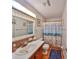 Cozy bathroom featuring mosaic tile accents, a decorative shower curtain, and nautical decor at 672 Allegheny Dr, Sun City Center, FL 33573