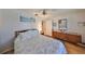 Well-lit bedroom with wood floors, ceiling fan, and large wood dresser at 672 Allegheny Dr, Sun City Center, FL 33573