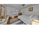Cozy bedroom features hardwood floors, ceiling fan, and decoratively patterned bedspread at 672 Allegheny Dr, Sun City Center, FL 33573