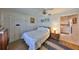 Bright bedroom with ceiling fan, closet, wood floors, and view into adjoining laundry room at 672 Allegheny Dr, Sun City Center, FL 33573