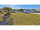 Charming home with a well-manicured front lawn, palm trees, and a screened garage at 672 Allegheny Dr, Sun City Center, FL 33573