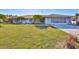 Charming single-story home with a well-manicured lawn and mature landscaping at 672 Allegheny Dr, Sun City Center, FL 33573