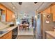 Charming kitchen featuring wood cabinets, stainless steel refrigerator, and adjacent dining area at 672 Allegheny Dr, Sun City Center, FL 33573