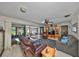 Bright living room featuring sliding doors to a screened-in lanai and comfortable seating at 672 Allegheny Dr, Sun City Center, FL 33573