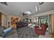 Inviting living room flowing into the kitchen and featuring sliding doors to a screened lanai at 672 Allegheny Dr, Sun City Center, FL 33573