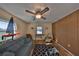 Cozy living room with ceiling fan, wood paneling, hardwood floors, and bright natural light at 672 Allegheny Dr, Sun City Center, FL 33573