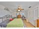 Cozy main bedroom with wood-look floors, and a ceiling fan at 672 Allegheny Dr, Sun City Center, FL 33573