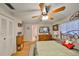 Bright main bedroom featuring wood-look floors, large closet, and ensuite bathroom at 672 Allegheny Dr, Sun City Center, FL 33573