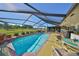 Stunning screened pool with views of the greenbelt, complemented by stylish outdoor furniture at 672 Allegheny Dr, Sun City Center, FL 33573