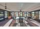 Bright sunroom featuring large windows, a ceiling fan, and comfortable seating at 672 Allegheny Dr, Sun City Center, FL 33573