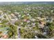 A birds-eye view captures the home with an enclosed pool within a leafy and idyllic neighborhood at 705 S West Shore Blvd, Tampa, FL 33609