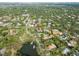 An aerial photograph shows the house with a private pond nearby in a lovely residential area at 705 S West Shore Blvd, Tampa, FL 33609