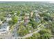 An aerial view shows the home nestled among mature trees and other houses in the neighborhood at 705 S West Shore Blvd, Tampa, FL 33609