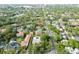 An aerial view captures the house in a tranquil neighborhood surrounded by a lush, green landscape at 705 S West Shore Blvd, Tampa, FL 33609
