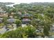 An aerial view shows a home with a red roof, an enclosed pool and lush, mature landscaping at 705 S West Shore Blvd, Tampa, FL 33609