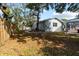 Backyard with mature trees, a wooden fence, and access to a screened-in patio at 705 S West Shore Blvd, Tampa, FL 33609