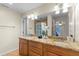 Elegant bathroom with double sinks, granite countertops, and ample cabinet space at 705 S West Shore Blvd, Tampa, FL 33609