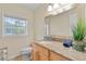 Bright bathroom featuring a single sink, granite countertops, and a large mirror at 705 S West Shore Blvd, Tampa, FL 33609