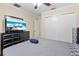 Bedroom with a ceiling fan, large dresser, hardwood flooring, and a TV at 705 S West Shore Blvd, Tampa, FL 33609