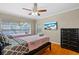 Bright bedroom featuring twin beds, a dresser, and a large window with a view of the pool at 705 S West Shore Blvd, Tampa, FL 33609