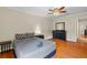 Comfortable bedroom featuring a ceiling fan and large dresser and smooth hardwood flooring at 705 S West Shore Blvd, Tampa, FL 33609
