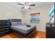 Comfortable bedroom featuring a ceiling fan and large dresser and smooth hardwood flooring at 705 S West Shore Blvd, Tampa, FL 33609