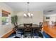 Dining room with hardwood floors, chandelier, and views into kitchen and living spaces at 705 S West Shore Blvd, Tampa, FL 33609