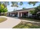 Charming single-story home with red door, awning-covered windows, and a curved driveway at 705 S West Shore Blvd, Tampa, FL 33609