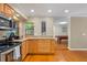 Charming eat-in kitchen featuring granite countertops, stainless appliances, and direct access to the billiards room at 705 S West Shore Blvd, Tampa, FL 33609