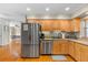 Bright kitchen features stainless steel appliances, wood cabinets, and granite countertops at 705 S West Shore Blvd, Tampa, FL 33609