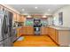 Bright kitchen features stainless steel appliances and beautiful natural wood cabinetry and hardwood flooring at 705 S West Shore Blvd, Tampa, FL 33609