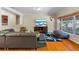 Cozy living room with hardwood floors, a large window, and a TV at 705 S West Shore Blvd, Tampa, FL 33609