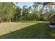 Expansive backyard with lush green grass and a partial view of the house at 7182 Griffin Rd, Brooksville, FL 34601