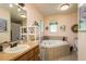 Bathroom features a large soaking tub, vanity, and window at 7182 Griffin Rd, Brooksville, FL 34601