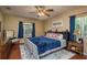 This bedroom features hardwood floors, a ceiling fan, and natural light at 7182 Griffin Rd, Brooksville, FL 34601