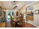 Dining area with vaulted ceiling features wood floors, light fixture and access to kitchen at 7182 Griffin Rd, Brooksville, FL 34601