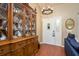 Inviting foyer featuring hardwood floors, chandelier, display cabinet, and a view into the adjacent living area at 7182 Griffin Rd, Brooksville, FL 34601