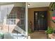 Welcoming front entrance with decorative wreath, potted plants, and a stone accent wall visible from the porch at 7182 Griffin Rd, Brooksville, FL 34601