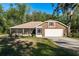 Charming single-story home with a well-maintained lawn, screened in porch and an attached two car garage at 7182 Griffin Rd, Brooksville, FL 34601